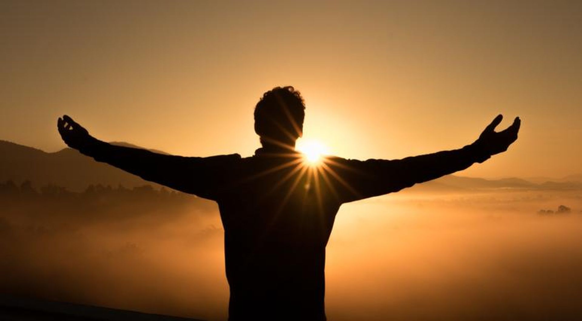 A person reaching toward the sun, representing life's purpose.