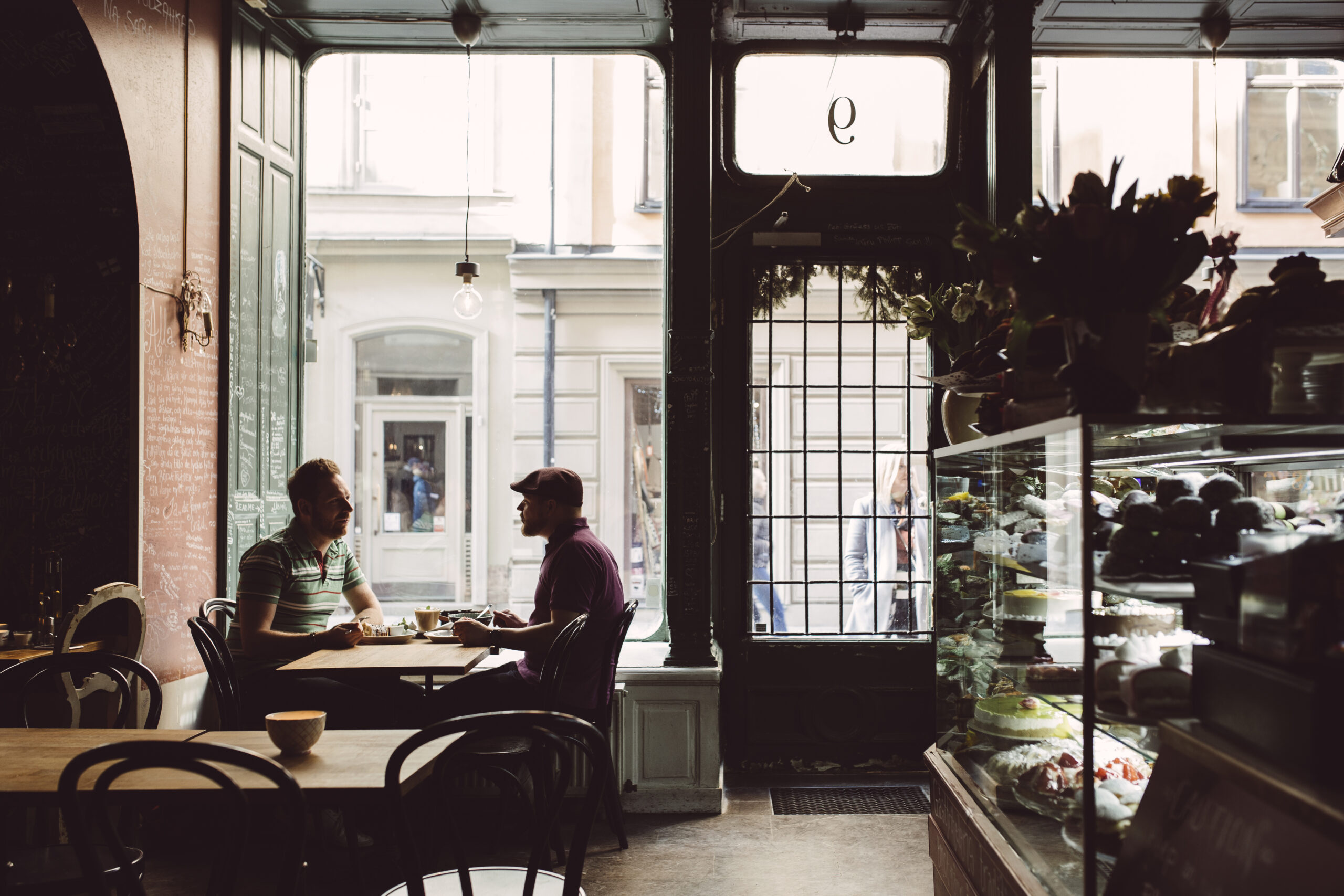 Two people enjoying coffee at a cafe.