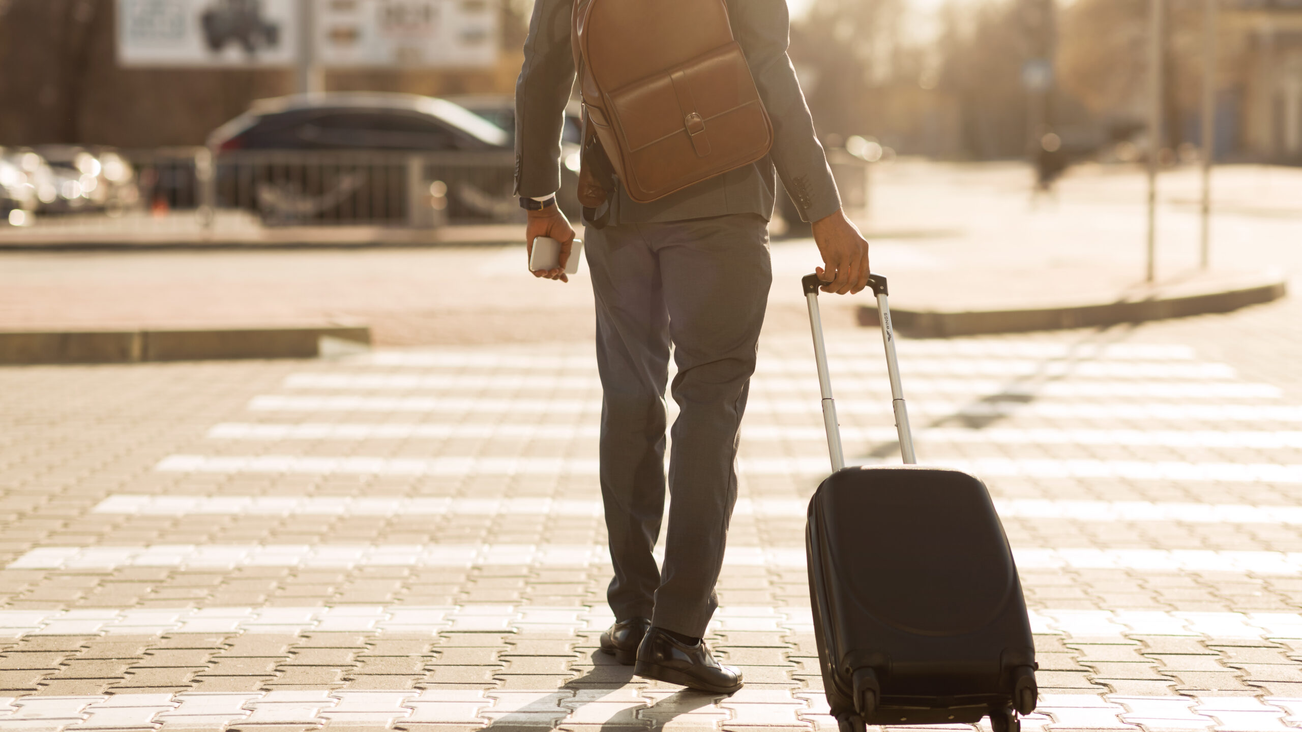 A man in a suit holding a suitcase.